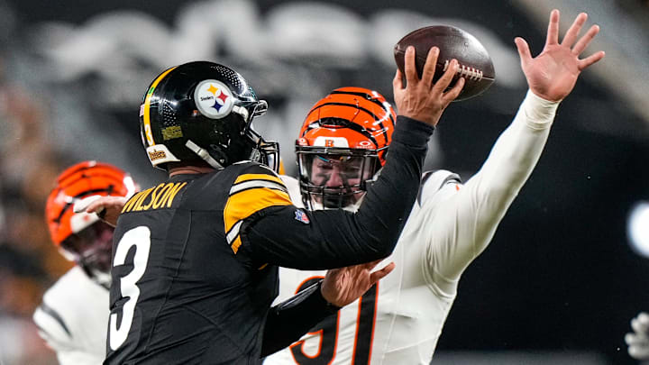 Cincinnati Bengals defensive end Trey Hendrickson (91) pressures Pittsburgh Steelers quarterback Russell Wilson (3) in the first quarter of the NFL Week 18 game between the Pittsburgh Steelers and the Cincinnati Bengals at Acrisure Stadium in Pittsburgh on Saturday, Jan. 4, 2025.