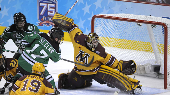 Apr 10, 2014; Philadelphia, PA, USA; Minnesota Gophers goaltender Adam Wilcox (32) makes a save against North Dakota Sioux forward Colten St. Clair (17) during the first period in the semifinals of the Frozen Four college ice hockey tournament at Wells Fargo Center. Mandatory Credit: Eric Hartline-Imagn Images