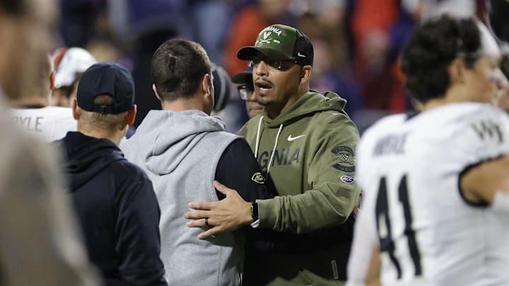 Nov 8, 2025; Charlottesville, Virginia, USA; Virginia Cavaliers head coach Tony Elliott (right) greets Wake Forest Demon Deacons head coach Jake Dickert (left) after their game at Scott Stadium. Mandatory Credit: Amber Searls-Imagn Images Nov 8, 2025; Charlottesville, Virginia, USA; Virginia Cavaliers head coach Tony Elliott (right) greets Wake Forest Demon Deacons head coach Jake Dickert (left) after their game at Scott Stadium. Mandatory Credit: Amber Searls-Imagn Images