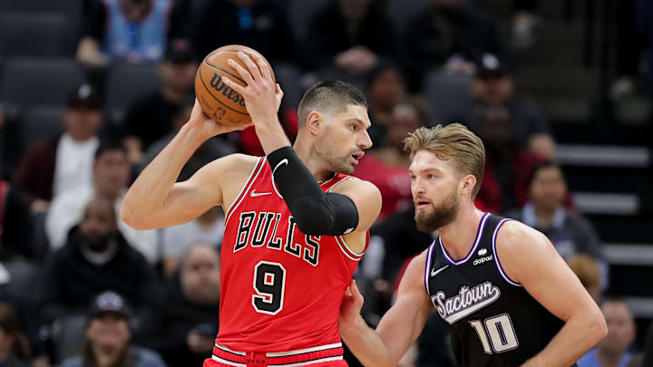 Mar 14, 2022; Sacramento, California, USA; Chicago Bulls center Nikola Vucevic (9) controls the ball against Sacramento Kings forward Domantas Sabonis (10) during the first quarter at Golden 1 Center. Mandatory Credit: Sergio Estrada-Imagn Images