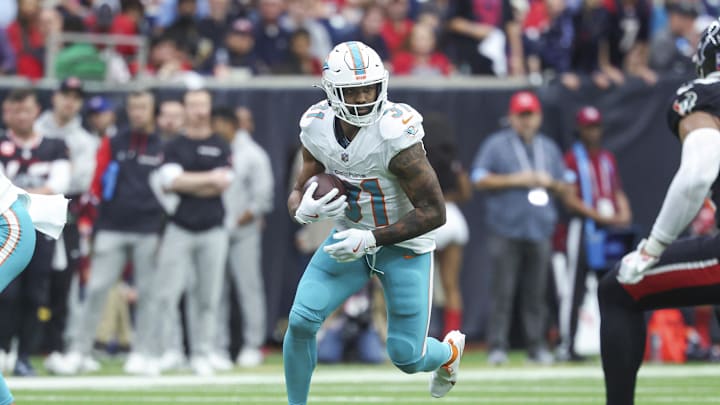 Dec 15, 2024; Houston, Texas, USA; Miami Dolphins running back Raheem Mostert (31) runs with the ball during the game against the Houston Texans at NRG Stadium. Mandatory Credit: Troy Taormina-Imagn Images