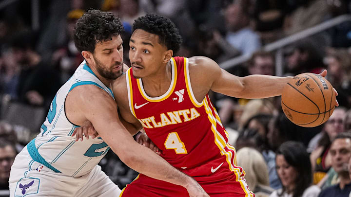Apr 10, 2024; Atlanta, Georgia, USA; Atlanta Hawks guard Kobe Bufkin (4) is defended by Charlotte Hornets guard Vasilije Micic (22) during the second half at State Farm Arena. Mandatory Credit: Dale Zanine-Imagn Images