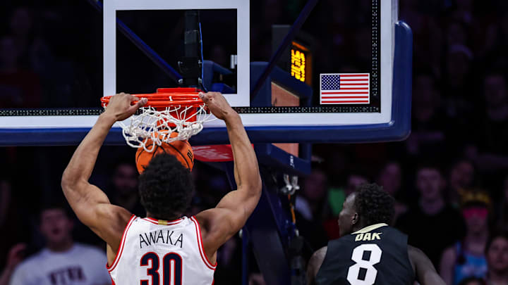 Jan 25, 2025; Tucson, Arizona, USA; Arizona Wildcats forward Tobe Awaka (30) dunks the ball while Colorado Buffaloes forward Bangot Dak (8) fails to block him during the first half of the game at McKale Center. Mandatory Credit: Aryanna Frank-Imagn Images