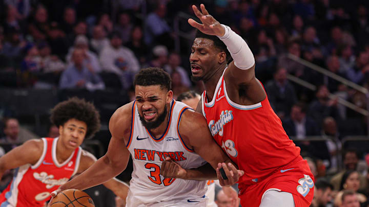 Jan 27, 2025; New York, New York, USA; New York Knicks center Karl-Anthony Towns (32) goes to the basket as Memphis Grizzlies forward Jaren Jackson Jr. (13) defends during the second half at Madison Square Garden. Mandatory Credit: Vincent Carchietta-Imagn Images