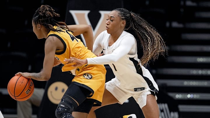 Missouri guard Lisa Thompson (4) is defended by Vanderbilt guard Mikayla Blakes (1) during the second half of an NCAA college basketball game at Memorial Gymnasium Thursday, Jan. 8, 2026, in Nashville, Tenn. Vanderbilt won 99-68.