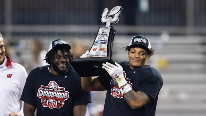 Dec 27, 2022; Phoenix, Arizona, USA; Wisconsin Badgers running back Braelon Allen celebrates with the trophy alongside linebacker Jordan Turner after defeating the Oklahoma State Cowboys during the 2022 Guaranteed Rate Bowl at Chase Field. Dec 27, 2022; Phoenix, Arizona, USA; Wisconsin Badgers running back Braelon Allen celebrates with the trophy alongside linebacker Jordan Turner after defeating the Oklahoma State Cowboys during the 2022 Guaranteed Rate Bowl at Chase Field.