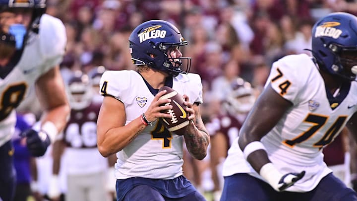 Sep 14, 2024; Starkville, Mississippi, USA; Toledo Rockets quarterback Tucker Gleason (4) looks to pass against the Mississippi State Bulldogs during the first quarter at Davis Wade Stadium at Scott Field. Mandatory Credit: Matt Bush-Imagn Images