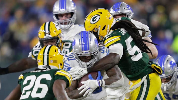 Detroit Lions running back Jamaal Williams (30) is tackled by Green Bay Packers linebacker De'Vondre Campbell (59) as safety Darnell Savage (26) moves in on the play during their football game Sunday, January 8, 2023, at Lambeau Field in Green Bay, Wis. Dan Powers/USA TODAY NETWORK-Wisconsin

Apc Packvsdetroit 0108232191djp
