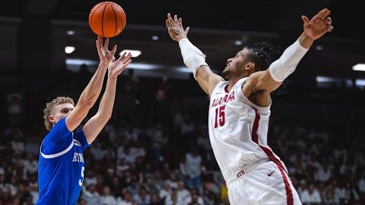 Feb 22, 2025; Tuscaloosa, Alabama, USA; Kentucky Wildcats guard Collin Chandler (5) shoots against Alabama Crimson Tide forward Jarin Stevenson (15) during the second half at Coleman Coliseum. Mandatory Credit: Will McLelland-Imagn Images