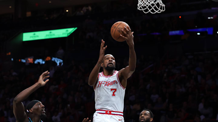 Feb 28, 2026; Miami, Florida, USA; Houston Rockets forward Kevin Durant (7) drives to the basket against Miami Heat center Bam Adebayo (13) and forward Andrew Wiggins (22) during the second quarter at Kaseya Center. Mandatory Credit: Sam Navarro-Imagn Images