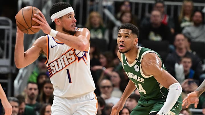 Apr 1, 2025; Milwaukee, Wisconsin, USA;  Phoenix Suns guard Devin Booker (1) looks for a shot against Milwaukee Bucks forward Giannis Antetokounmpo (34) in the third quarter at Fiserv Forum. Mandatory Credit: Benny Sieu-Imagn Images