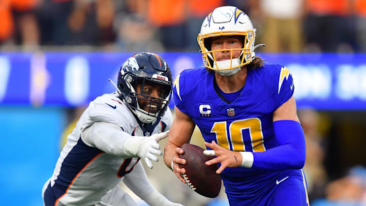 Dec 10, 2023; Inglewood, California, USA; Los Angeles Chargers quarterback Justin Herbert (10) moves out to pass against the defense of Denver Broncos linebacker Jonathon Cooper (0) during the first half at SoFi Stadium. Mandatory Credit: Gary A. Vasquez-Imagn Images Dec 10, 2023; Inglewood, California, USA; Los Angeles Chargers quarterback Justin Herbert (10) moves out to pass against the defense of Denver Broncos linebacker Jonathon Cooper (0) during the first half at SoFi Stadium. Mandatory Credit: Gary A. Vasquez-Imagn Images