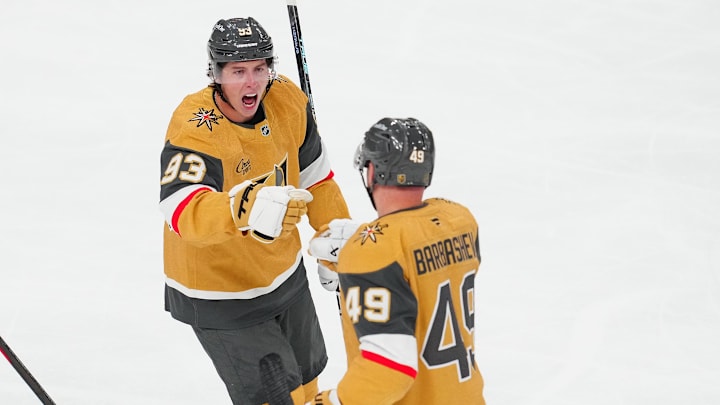 Oct 8, 2025; Las Vegas, Nevada, USA; Vegas Golden Knights right wing Mitch Marner (93) celebrates with Vegas Golden Knights left wing Ivan Barbashev (49) after assisting on a goal scored by Barbabshev against the Los Angeles Kings during the third period at T-Mobile Arena. Mandatory Credit: Stephen R. Sylvanie-Imagn Images