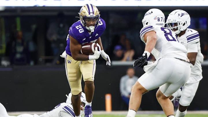 Huskies freshman linebacker Khmori House (28) returns an interception against Northwestern earlier in the season.
