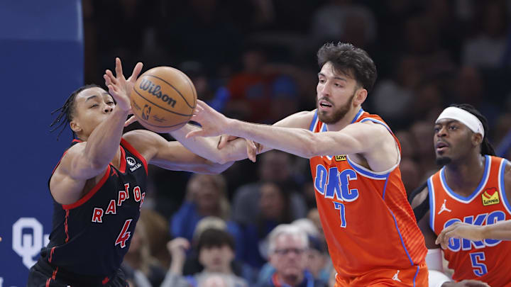 Jan 25, 2026; Oklahoma City, Oklahoma, USA; Toronto Raptors forward/guard Scottie Barnes (4) and Oklahoma City Thunder center/forward Chet Holmgren (7) reach for a loose ball during the second half at Paycom Center. Mandatory Credit: Alonzo Adams-Imagn Images