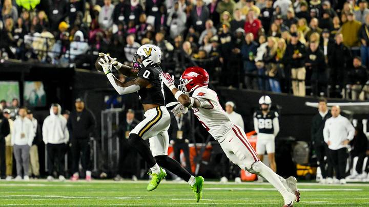 Oct 17, 2026; Nashville, Tennessee, USA; Vanderbilt Commodores wide receiver Junior Sherrill (0) makes a catch in front of Arkansas Razorbacks linebacker Khmori House (6) during the second half at FirstBank Stadium. Mandatory Credit: Steve Roberts-Imagn Images Oct 17, 2026; Nashville, Tennessee, USA; Vanderbilt Commodores wide receiver Junior Sherrill (0) makes a catch in front of Arkansas Razorbacks linebacker Khmori House (6) during the second half at FirstBank Stadium. Mandatory Credit: Steve Roberts-Imagn Images