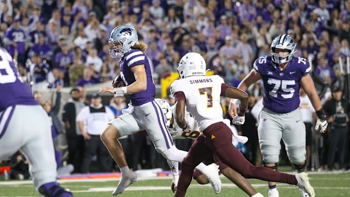 Nov 16, 2024; Manhattan, Kansas, USA; Kansas State Wildcats quarterback Avery Johnson (2) runs by Arizona State Sun Devils defensive back Shamari Simmons (7) for a touchdown in the third quarter at Bill Snyder Family Football Stadium. Mandatory Credit: Scott Sewell-Imagn Images