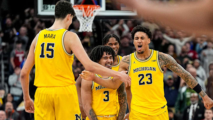 Michigan forward Yaxel Lendeborg celebrates a three-pointer with guard Elliot Cadeau (3), forward Morez Johnson Jr. (21) and center Aday Mara (15).