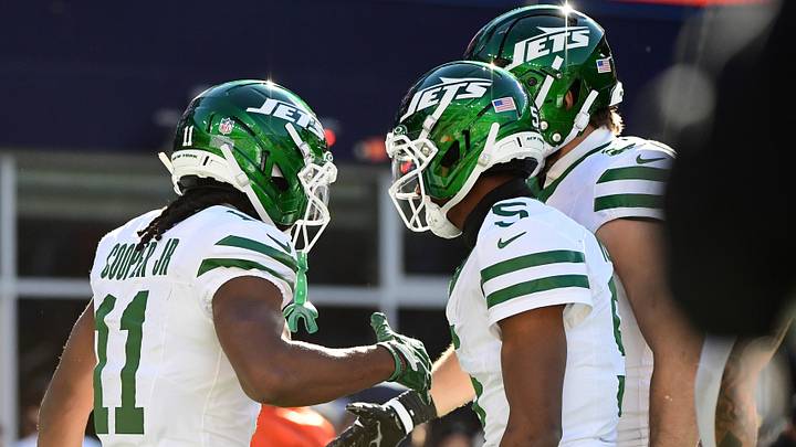 New York Jets wide receiver Omar Cooper Jr. (11) is congratulated by his teammates after scoring a touchdown during the second half against the New England Patriots at Gillette Stadium.