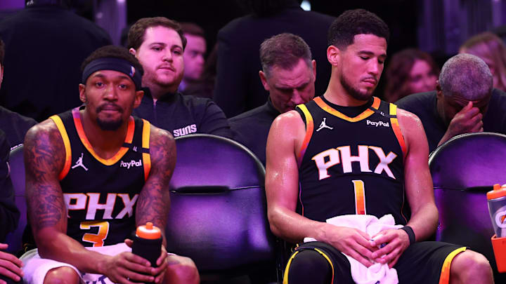 Apr 9, 2025; Phoenix, Arizona, USA; Phoenix Suns guard Bradley Beal (3) and guard Devin Booker (1) react on the bench against the Oklahoma City Thunder during the second half at Footprint Center. Mandatory Credit: Mark J. Rebilas-Imagn Images