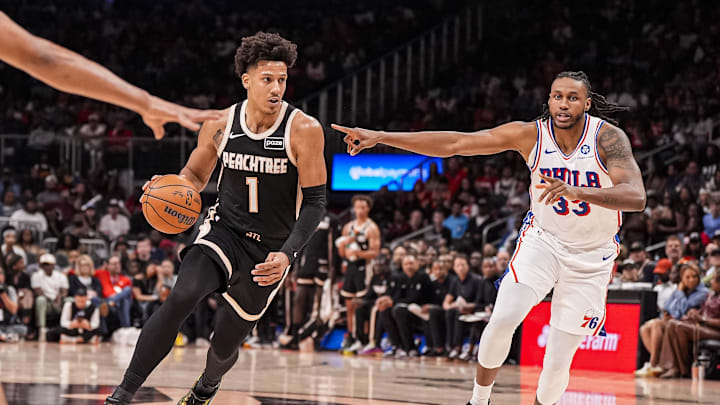 Mar 7, 2026; Atlanta, Georgia, USA; Atlanta Hawks forward Jalen Johnson (1) dribbles against Philadelphia 76ers forward Jabari Walker (33) during the second half at State Farm Arena. Mandatory Credit: Dale Zanine-Imagn Images