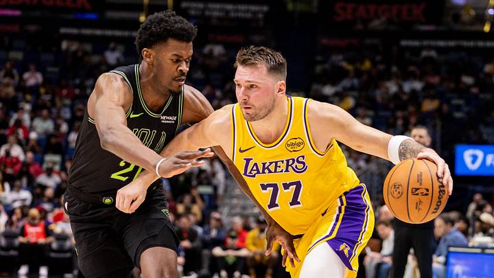 Jan 6, 2026; New Orleans, Louisiana, USA;  Los Angeles Lakers forward/guard Luka Doncic (77) dribbles against New Orleans Pelicans center Yves Missi (21) during the first half at Smoothie King Center. Mandatory Credit: Stephen Lew-Imagn Images