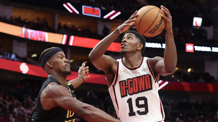 Feb 13, 2025; Houston, Texas, USA; Houston Rockets guard Nate Williams (19) drives against Golden State Warriors forward Jimmy Butler (10) in the second half at Toyota Center. Mandatory Credit: Thomas Shea-Imagn Images
