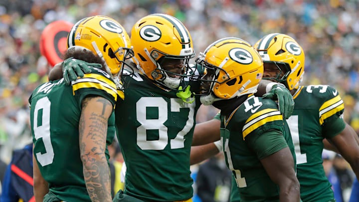 Green Bay Packers wide receiver Romeo Doubs (87) celebrates scoring a touchdown with wide receiver Christian Watson (9), wide receiver Jayden Reed (11) and running back Emanuel Wilson (31) against the Arizona Cardinals.