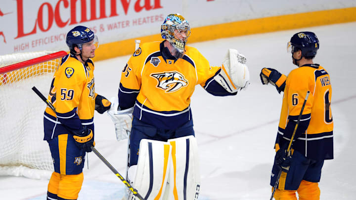 Feb 18, 2016; Nashville, TN, USA; Nashville Predators goalie Pekka Rinne (35) celebrates with defenseman Roman Josi (59) and Shea Weber (6) after a win against the Boston Bruins at Bridgestone Arena. The Predators won 2-0. Mandatory Credit: Christopher Hanewinckel-Imagn Images