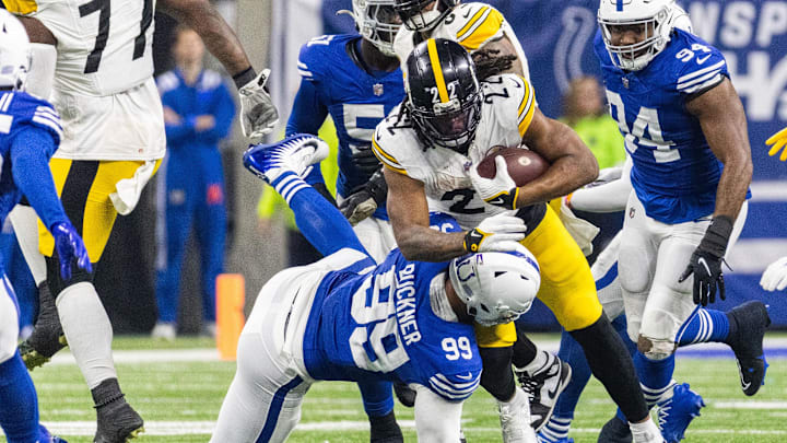 Dec 16, 2023; Indianapolis, Indiana, USA; Pittsburgh Steelers running back Najee Harris (22) runs the ball while Indianapolis Colts defensive tackle DeForest Buckner (99) defends in the second half at Lucas Oil Stadium. Mandatory Credit: Trevor Ruszkowski-Imagn Images