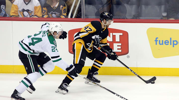 Oct 18, 2019; Pittsburgh, PA, USA;  Pittsburgh Penguins center Adam Johnson (47) moves the puck against Dallas Stars left wing Roope Hintz (24) during the third period at PPG PAINTS Arena. Pittsburgh won 4-2. Mandatory Credit: Charles LeClaire-Imagn Images