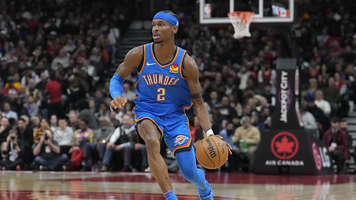Dec 5, 2024; Toronto, Ontario, CAN; Oklahoma City Thunder guard Shai Gilgeous-Alexander (2) dribbles the ball against the Toronto Raptors during the second half at Scotiabank Arena. Mandatory Credit: John E. Sokolowski-Imagn Images