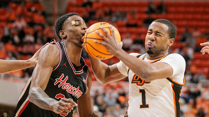 Dec 30, 2024; Stillwater, Oklahoma, USA; Oklahoma State Cowboys guard Bryce Thompson (1) collides with Houston Cougars guard Terrance Arceneaux (23) during the first half at Gallagher-Iba Arena. Mandatory Credit: William Purnell-Imagn Images Dec 30, 2024; Stillwater, Oklahoma, USA; Oklahoma State Cowboys guard Bryce Thompson (1) collides with Houston Cougars guard Terrance Arceneaux (23) during the first half at Gallagher-Iba Arena. Mandatory Credit: William Purnell-Imagn Images
