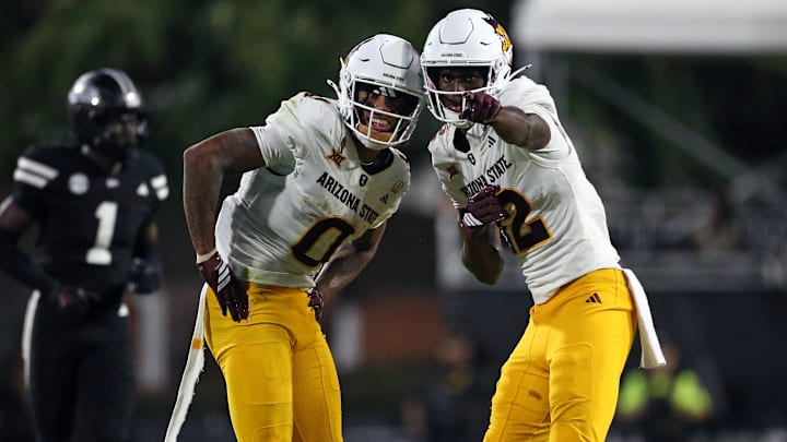 Sep 6, 2025; Starkville, Mississippi, USA; Arizona State Sun Devils wide receiver Jordyn Tyson (0) and wide receiver Malik McClain (12) react after a catch during the fourth quarter against the Mississippi State Bulldogs at Davis Wade Stadium at Scott Field. Mandatory Credit: Petre Thomas-Imagn Images