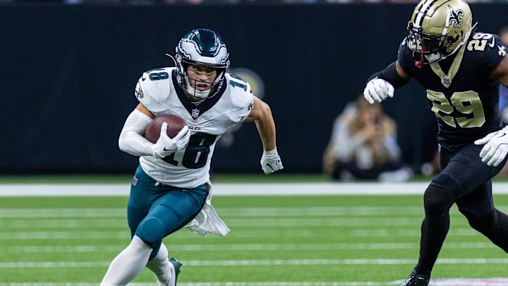 Sep 22, 2024; New Orleans, Louisiana, USA; Philadelphia Eagles wide receiver Britain Covey (18) runs a pass back against New Orleans Saints cornerback Paulson Adebo (29) during the first half at Caesars Superdome.