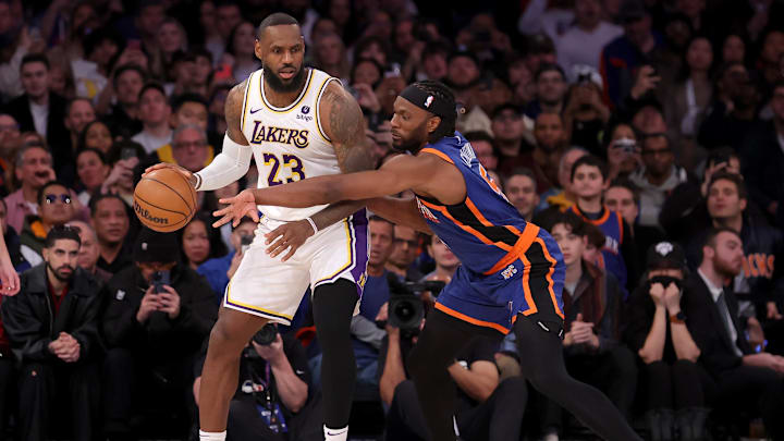 Feb 3, 2024; New York, New York, USA; Los Angeles Lakers forward LeBron James (23) controls the ball against New York Knicks forward Precious Achiuwa (5) during the fourth quarter at Madison Square Garden. Mandatory Credit: Brad Penner-Imagn Images