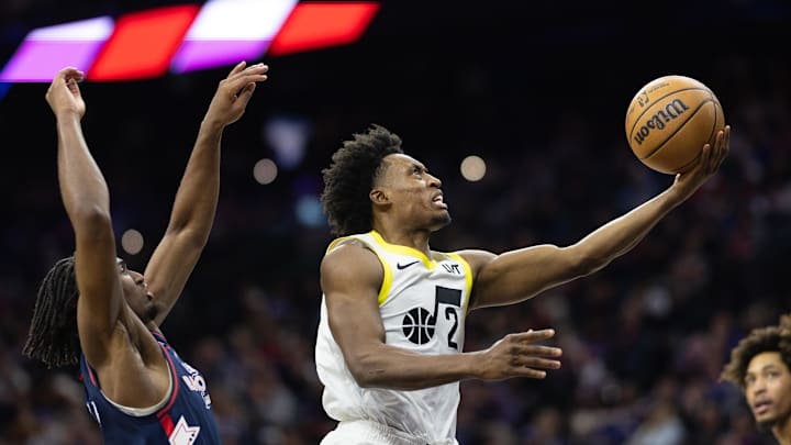 Jan 6, 2024; Philadelphia, Pennsylvania, USA; Utah Jazz guard Collin Sexton (2) drives for a score past Philadelphia 76ers guard Tyrese Maxey (0) during the fourth quarter at Wells Fargo Center. Mandatory Credit: Bill Streicher-Imagn Images