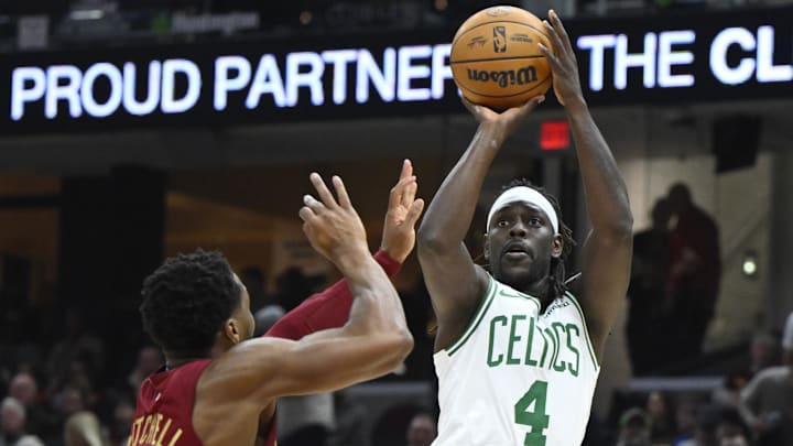Dec 1, 2024; Cleveland, Ohio, USA; Boston Celtics guard Jrue Holiday (4) shoots beside Cleveland Cavaliers guard Donovan Mitchell (45) in the second quarter at Rocket Mortgage FieldHouse. Mandatory Credit: David Richard-Imagn Images