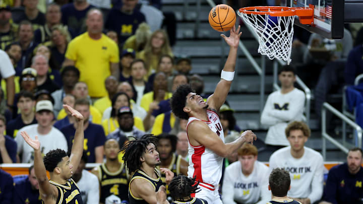 Apr 4, 2026; Indianapolis, IN, USA; Arizona Wildcats forward Koa Peat (10) shoots past Michigan Wolverines guard Elliot Cadeau (3) in the first half during a semifinal of the Final Four of the men's 2026 NCAA Tournament at Lucas Oil Stadium. Mandatory Credit: Trevor Ruszkowski-Imagn Images
