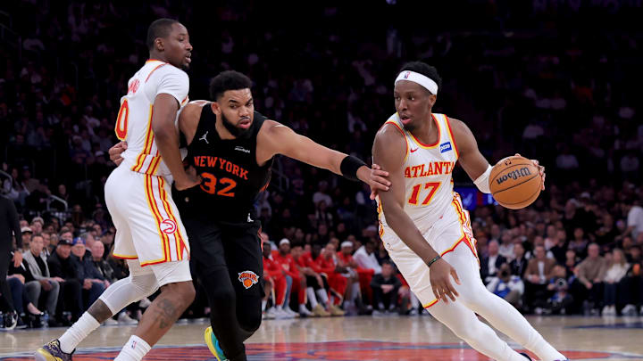 Apr 28, 2026; New York, New York, USA; Atlanta Hawks forward Onyeka Okongwu (17) drives to the basket around New York Knicks center Karl-Anthony Towns (32) as Hawks forward Jonathan Kuminga (0) sets a pick during the third quarter of game five of the first round of the 2026 NBA Playoffs at Madison Square Garden. Mandatory Credit: Brad Penner-Imagn Images