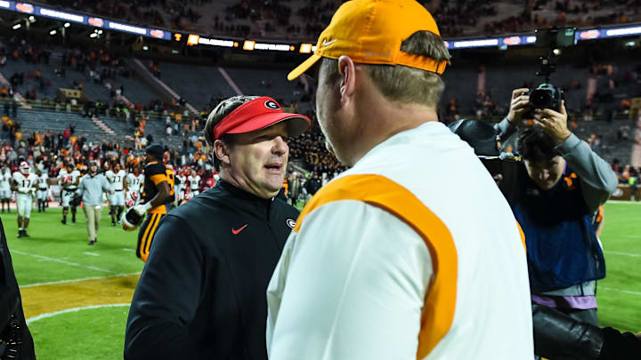 Nov 13, 2021; Knoxville, Tennessee, USA; Georgia Bulldogs head coach Kirby Smart (left) and Tennessee Volunteers head coach Josh Heupel (right) meet at midfield after the game at Neyland Stadium. Mandatory Credit: Bryan Lynn-Imagn Images Nov 13, 2021; Knoxville, Tennessee, USA; Georgia Bulldogs head coach Kirby Smart (left) and Tennessee Volunteers head coach Josh Heupel (right) meet at midfield after the game at Neyland Stadium. Mandatory Credit: Bryan Lynn-Imagn Images