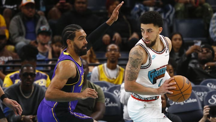 Nov 6, 2024; Memphis, Tennessee, USA; Memphis Grizzlies guard Scotty Pippen Jr. (1) handles the ball as Los Angeles Lakers guard Gabe Vincent (7) defends during the first half at FedExForum. Mandatory Credit: Petre Thomas-Imagn Images