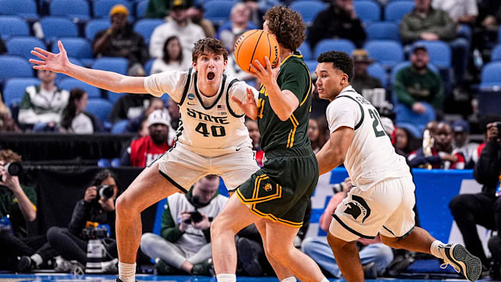 Michigan State forward Brennan Walton (40) and guard Nick Sanders (20) defend North Dakota State guard Max Majerle (11) during the second half of NCAA Tournament First Round at KeyBank Center in Buffalo on Thursday, March 19, 2026. Michigan State forward Brennan Walton (40) and guard Nick Sanders (20) defend North Dakota State guard Max Majerle (11) during the second half of NCAA Tournament First Round at KeyBank Center in Buffalo on Thursday, March 19, 2026.