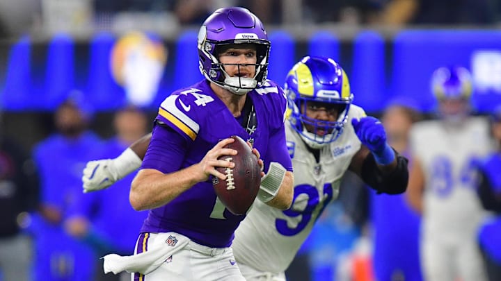 Oct 24, 2024; Inglewood, California, USA; Minnesota Vikings quarterback Sam Darnold (14) runs the ball ahead of Los Angeles Rams defensive tackle Kobie Turner (91) during the second half at SoFi Stadium. Oct 24, 2024; Inglewood, California, USA; Minnesota Vikings quarterback Sam Darnold (14) runs the ball ahead of Los Angeles Rams defensive tackle Kobie Turner (91) during the second half at SoFi Stadium.
