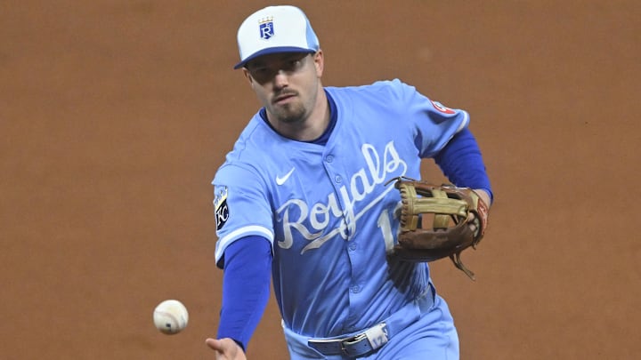 Sep 9, 2025; Cleveland, Ohio, USA; Kansas City Royals second baseman Nick Loftin (12) tosses the ball to first base in the seventh inning against the Cleveland Guardians at Progressive Field. Mandatory Credit: David Richard-Imagn Images