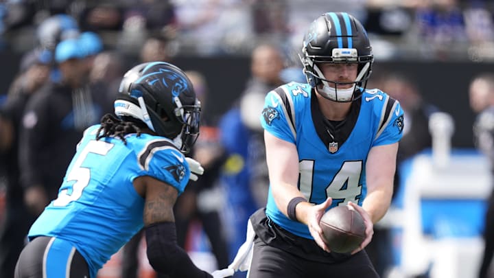 Oct 26, 2025; Charlotte, North Carolina, USA; Carolina Panthers quarterback Andy Dalton (14) hands off to running back Rico Dowdle (5) during the first half against the Buffalo Bills at Bank of America Stadium. Mandatory Credit: Jim Dedmon-Imagn Images Oct 26, 2025; Charlotte, North Carolina, USA; Carolina Panthers quarterback Andy Dalton (14) hands off to running back Rico Dowdle (5) during the first half against the Buffalo Bills at Bank of America Stadium. Mandatory Credit: Jim Dedmon-Imagn Images