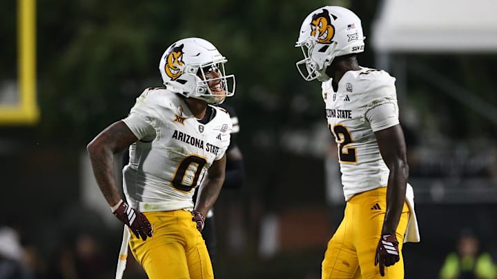 Sep 6, 2025; Starkville, Mississippi, USA; Arizona State Sun Devils wide receiver Jordyn Tyson (0) and wide receiver Malik McClain (12) react after a catch during the fourth quarter against the Mississippi State Bulldogs at Davis Wade Stadium at Scott Field. Mandatory Credit: Petre Thomas-Imagn Images