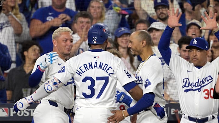 Oct 11, 2024; Los Angeles, California, USA; Los Angeles Dodgers outfielder Teoscar Hernandez (37) celebrates with shortstop Miguel Rojas (11) and shortstop Mookie Betts (50) after hitting a solo home run in the seventh inning against the San Diego Padres during game five of the NLDS for the 2024 MLB Playoffs at Dodger Stadium. Mandatory Credit: Jayne Kamin-Oncea-Imagn Images