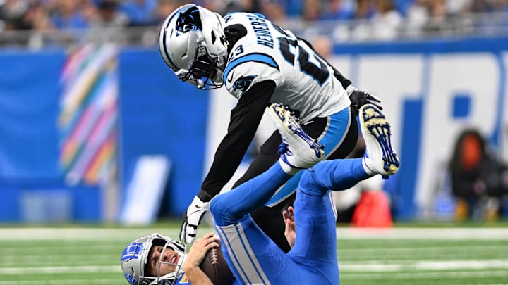 Oct 8, 2023; Detroit, Michigan, USA; Detroit Lions quarterback Jared Goff (16) is sacked by Carolina Panthers cornerback CJ Henderson (23) in the third quarter at Ford Field. Mandatory Credit: Lon Horwedel-Imagn Images