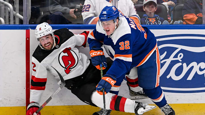 Mar 24, 2024; Elmont, New York, USA;  New York Islanders center Kyle MacLean (32) checks New Jersey